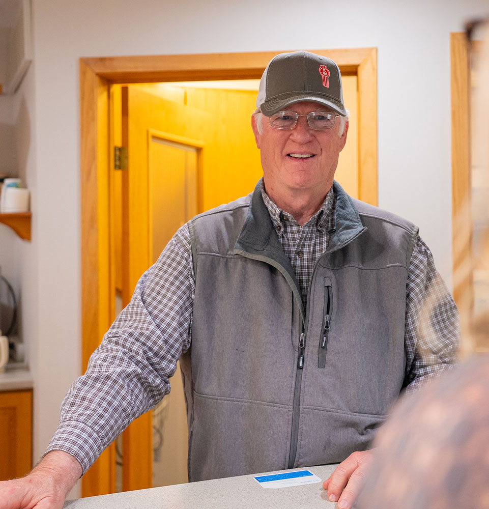 man with hat at front desk